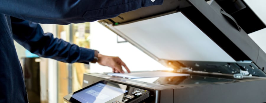 close up of someone using a copy machine